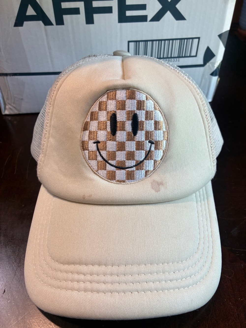Beige Trucker Hat with Checkerboard Smile Patch